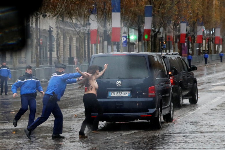 A protester tries to jump into the motorcade of President Donald Trump on his way to the commemoration ceremony for Armistice Day in Paris, France on November 11, 2018.